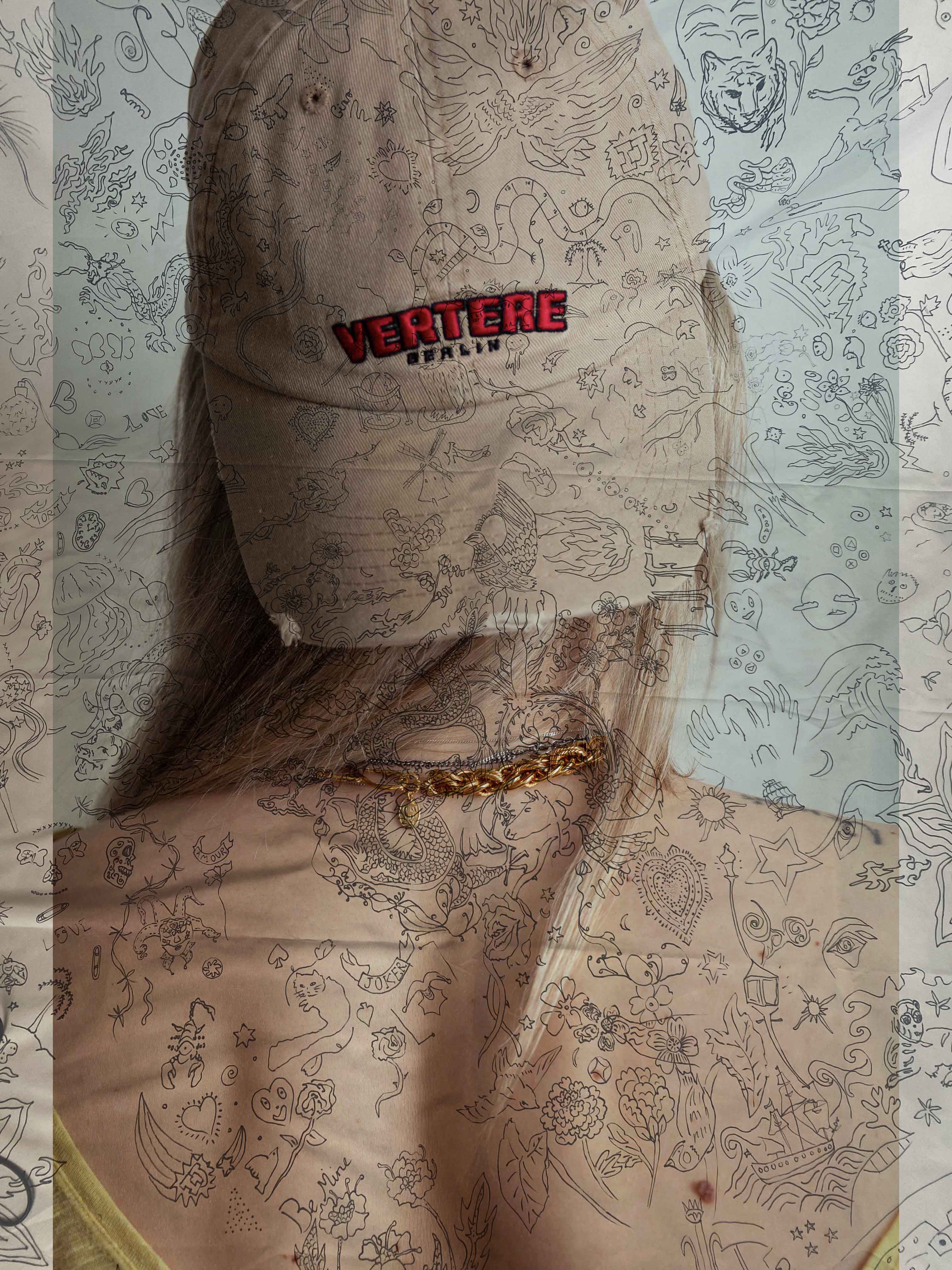 tattoos over cap and necklace portrait